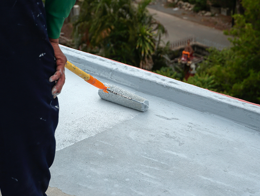 Application of waterproofing coating on flat roof surface