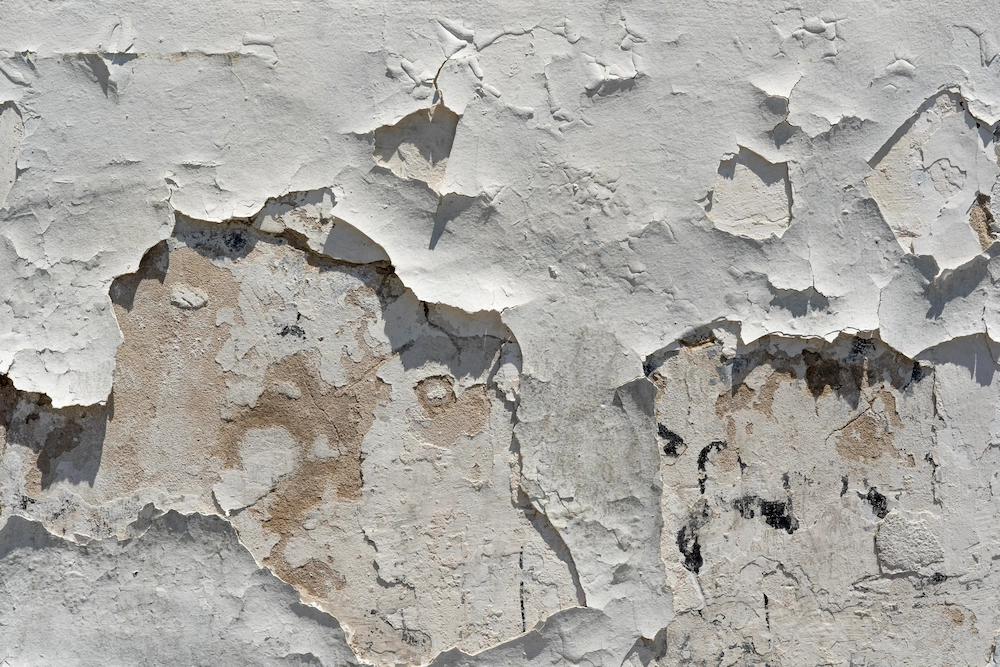 Close-up of spalling concrete wall requiring repair in Singapore