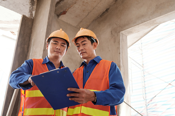 Building inspectors reviewing site conditions for waterproofing works