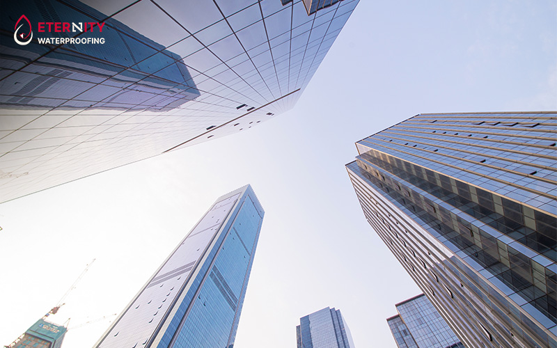 Skyscrapers viewed from below, highlighting the challenges of waterproofing.